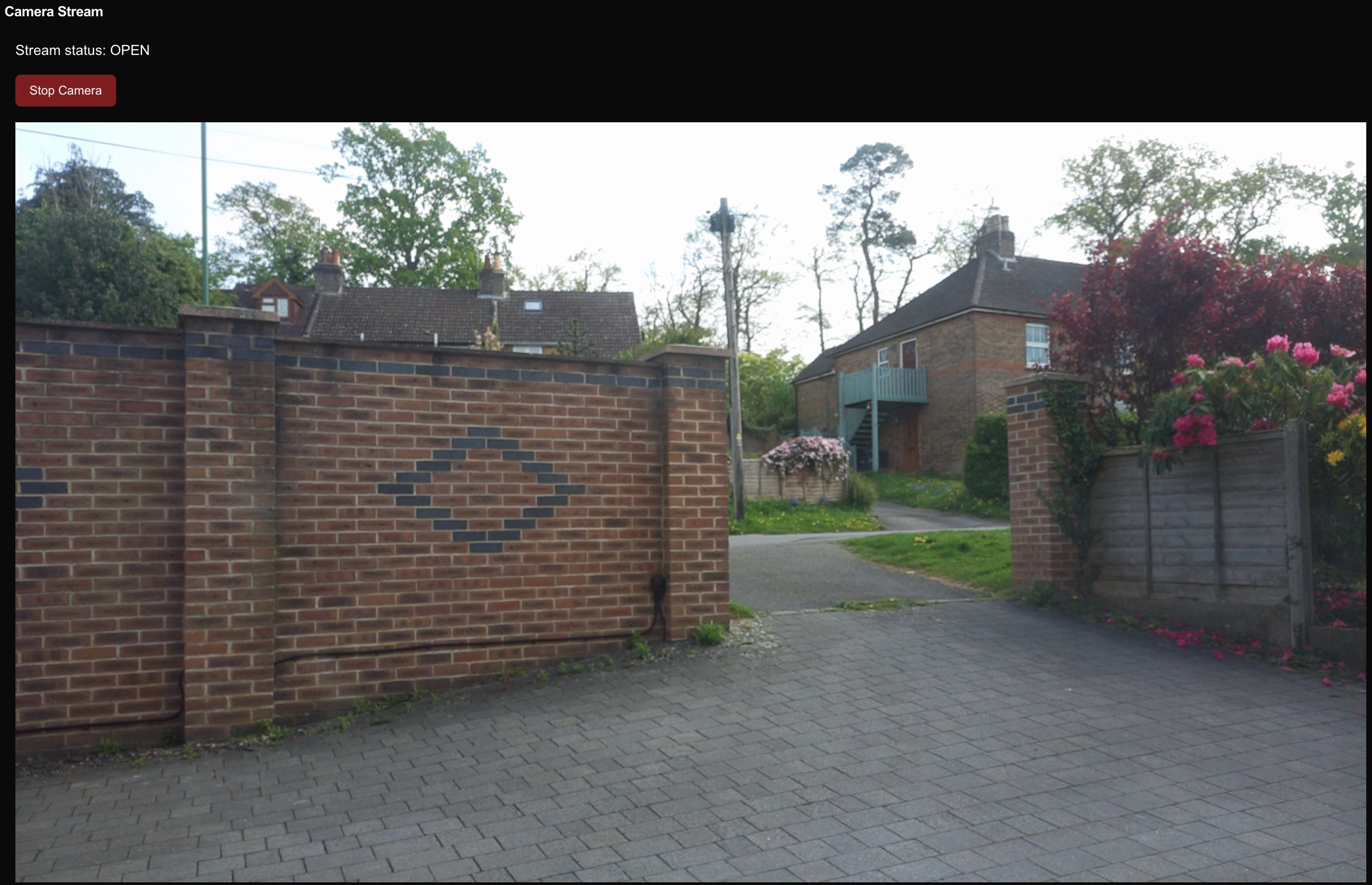 Picture outside of house, looking out onto a main road.